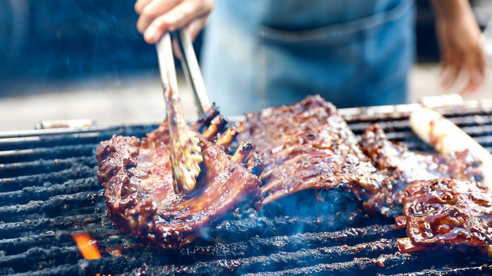 man grilling ribs