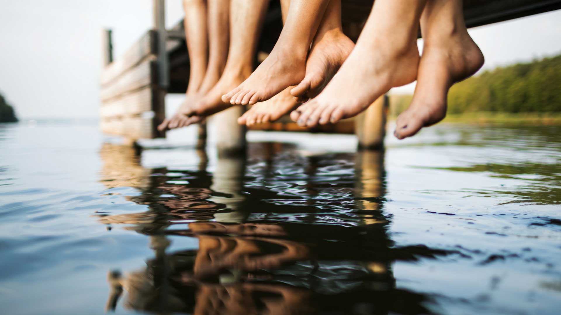 feet dangling in lake