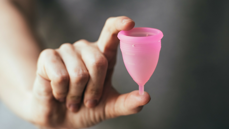 woman holding menstrual cup