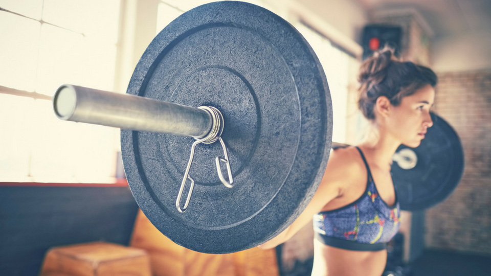 woman lifting with barbell