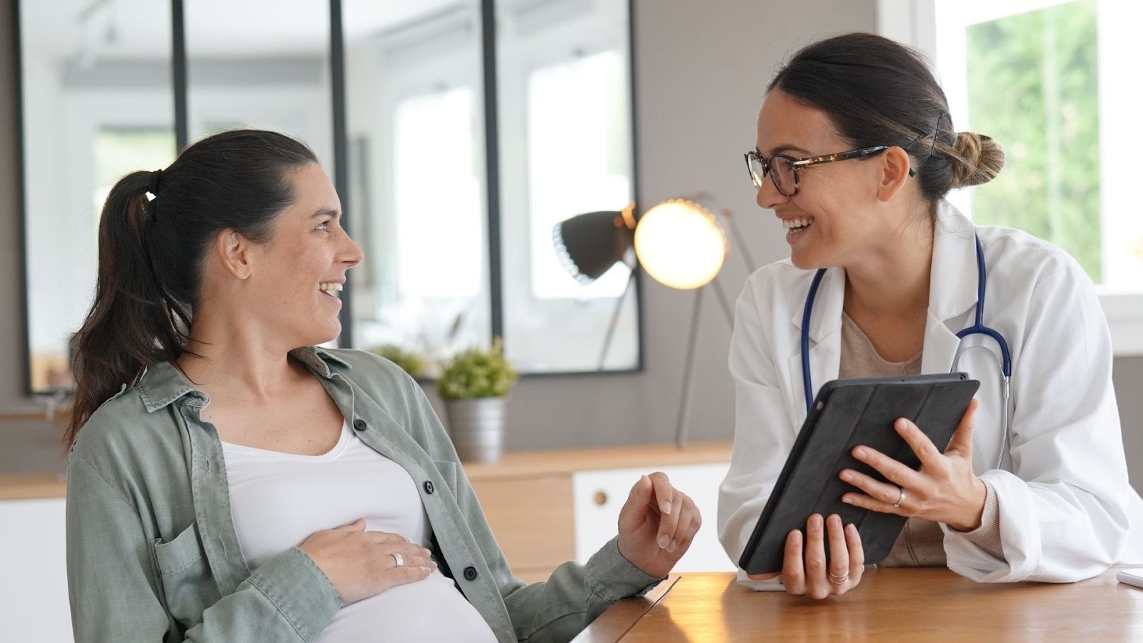 Pregnant Woman Talking to Doctor about Preventive Healthcare