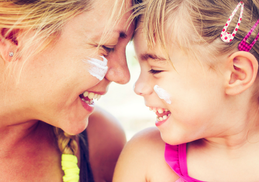 Mom and Daughter Smiling with Sunscreen