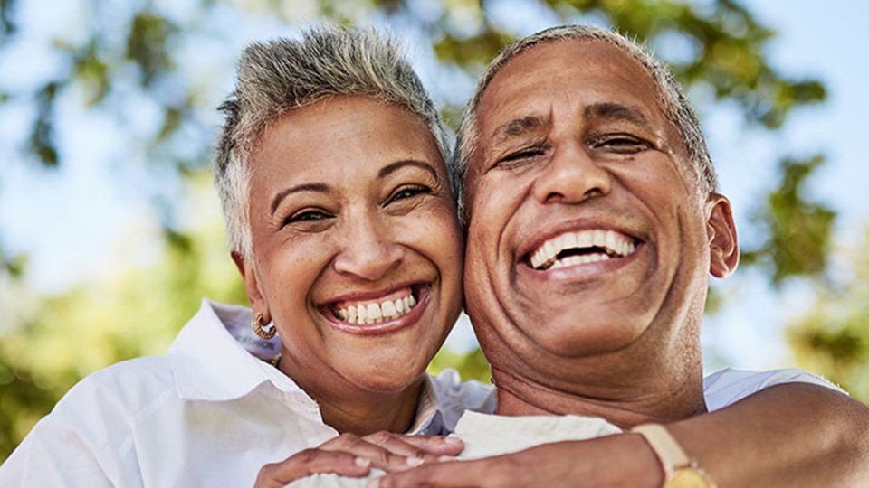 Two people hugging and smiling