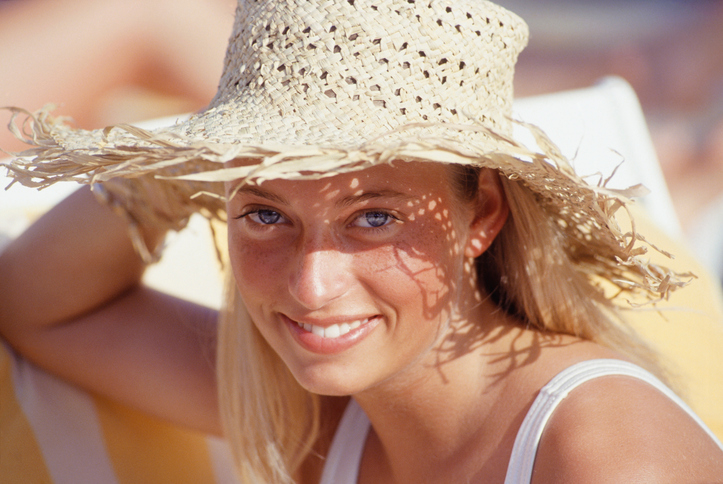 Young woman wearing straw hat, portrait