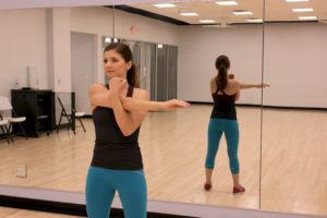 Girl stretching arm across her body